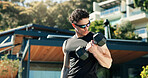 Bodybuilder, man and outdoor with dumbbells for training, muscle development and health. Sunglasses, fitness and athlete person with weights for exercise by home for endurance, challenge and workout