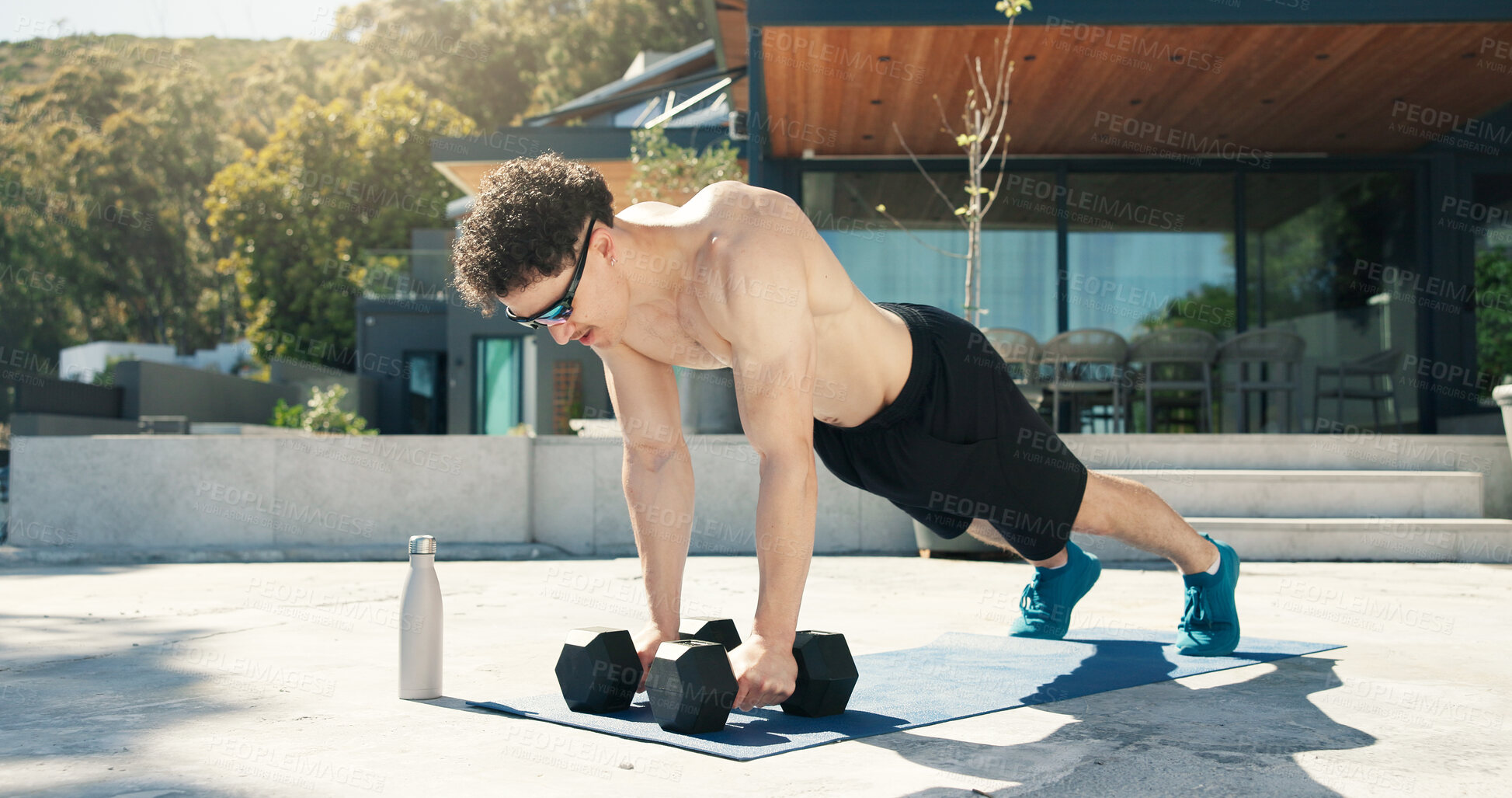 Buy stock photo Athlete, man and outdoor with dumbbells for fitness, muscle development and health. Sunglasses, workout and bodybuilder person with weights for exercise by home for push up, challenge and training