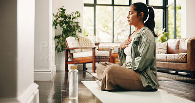 Buy stock photo Woman, meditation and breathing in house with yoga mat, chakra healing and spirituality for wellness. Zen, mature person and mindfulness in lounge with breathwork exercise, peace and holistic health.