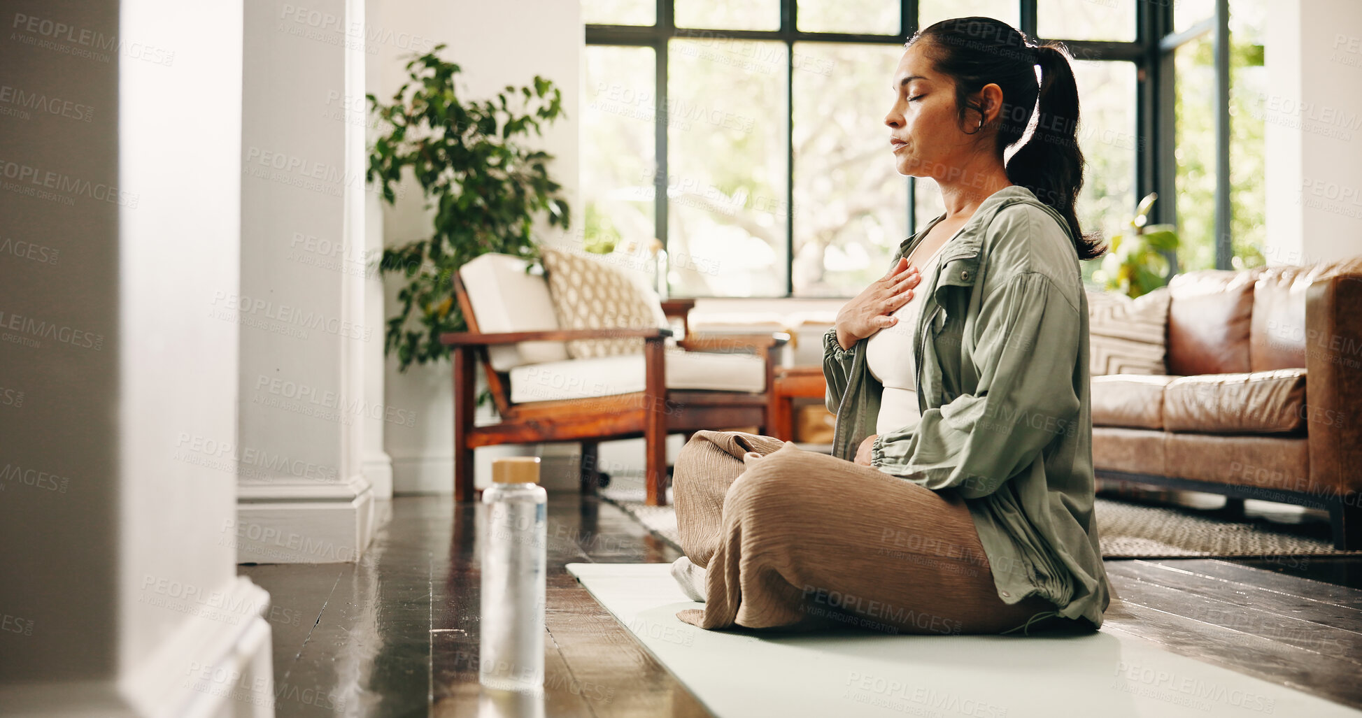 Buy stock photo Woman, meditation and breathing in house with yoga mat, chakra healing and spirituality for wellness. Zen, mature person and mindfulness in lounge with breathwork exercise, peace and holistic health.