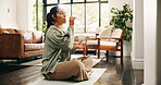 Yoga, woman and drinking water in living room with bottle, fitness and hydration break for wellness. Flare, mature person and liquid beverage in home lounge with exercise rest, thirst and self care.
