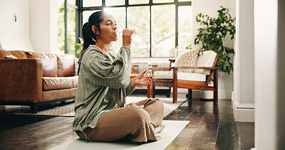 Buy stock photo Yoga, woman and drinking water in living room with bottle, fitness and hydration break for wellness. Flare, mature person and liquid beverage in home lounge with exercise rest, thirst and self care.
