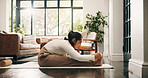 Fitness, stretching and woman with yoga mat in house, morning practice or flexibility routine for health. Holistic exercise, pilates or mature person with forward bend in lounge, posture and wellness