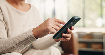 Buy stock photo Woman, hands and typing with phone in home for social media, communication or network. Scroll, female person or user browsing on mobile smartphone app or research for online chat or texting in house