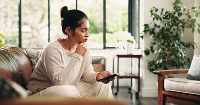 Buy stock photo Woman, thinking and research with phone on sofa in home for checklist, schedule or planning. Mature person, thoughtful or user browsing with mobile smartphone or app for online connection or network