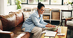 Woman, finance or documents with laptop in home for budget planning, bills or expenses. Female person, accounting or checklist with paperwork on sofa for financial report or asset management in house