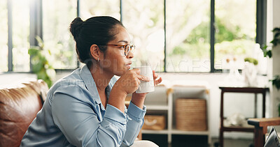 Buy stock photo Serious, woman and thinking with coffee on sofa to start morning, inspiration and self reflection. Home, calm person and thoughtful with hot beverage in living room for planning day and contemplating