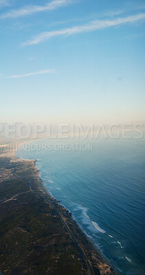 Buy stock photo Aerial view, seaside and coast with sky, mountains and cliff with space, outdoor and nature in summer. Ocean, shoreline and water with landscape, beach and above for hills with clouds on horizon
