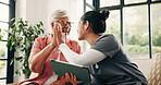 High five, medical and tablet with nurse and old woman in home living room for success or support. App, healthcare or motivation with caregiver and senior patient in apartment for results celebration