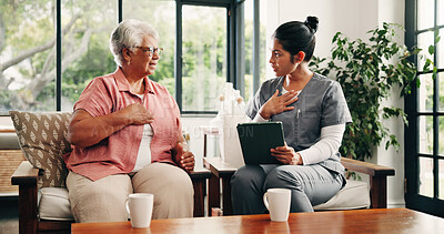 Buy stock photo Breathing, tablet and senior woman with nurse in home living room for consulting, feedback or healthcare. App, chest and old patient speaking in apartment to caregiver, medical checkup or support