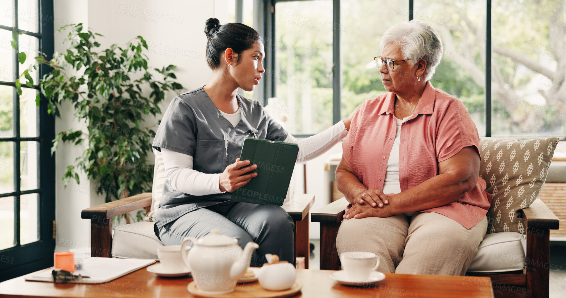 Buy stock photo Healthcare, tablet and senior woman with nurse in home living room for consulting, feedback or review. App, medical checkup and old patient speaking in apartment with caregiver, diagnosis or support