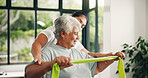 Woman, physiotherapy or senior with resistance band for arm exercise or muscle recovery in clinic. Female person, physio or helping elderly patient with physiotherapist for support in health center 