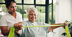Woman, physiotherapist or elderly with resistance band for arm exercise or muscle recovery in clinic. Female person, physio or helping senior patient with physiotherapy for support in health center 
