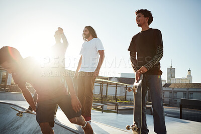 Buy stock photo Skateboard, hobby and friends in city for sport, competition challenge and start exercise by bowl. Outdoor, group and men at skate park for action, performance or ready to practice balance with flare