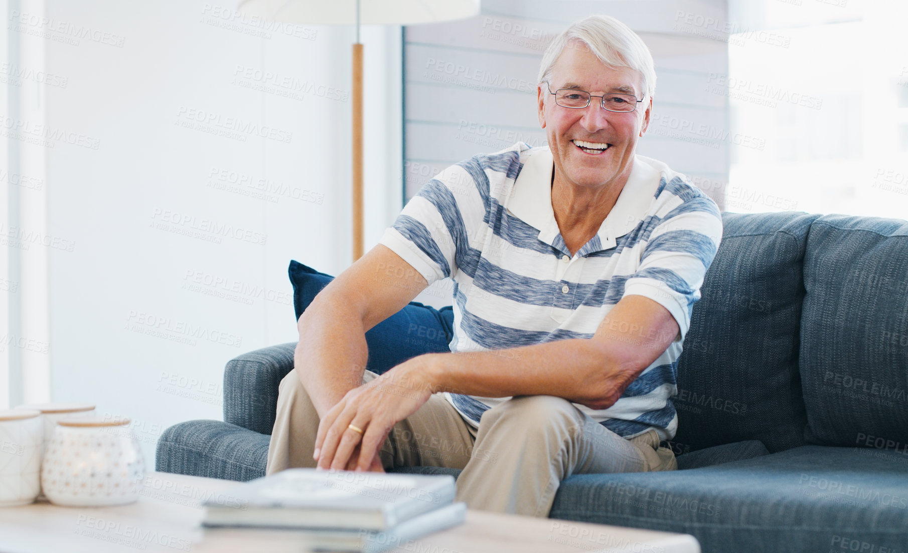 Buy stock photo Happy, confident and portrait of senior man on sofa with calm, positive attitude and peace on weekend. Smile, relax and elderly male person in retirement in living room at apartment in London.