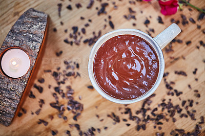 Buy stock photo Cup, chocolate and candle for aromatherapy in empty room with cloves, herbs and above with organic product. Mug, dessert and flowers with mousse, drink and beverage in wellness spa at luxury resort