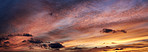 Sunset, orange and blue sky with clouds for weather, atmosphere and empty space. Natural, background and air with sunshine in evening for aesthetic, wallpaper and scenic view for nature or climate