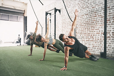 Buy stock photo Fitness, personal trainer and side plank with people in gym for core workout, class and health. Coaching, exercise club and training partner with men and woman in sports center for challenge