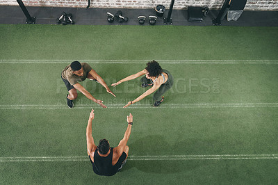 Buy stock photo Group, squat and fitness with personal trainer in gym, exercise or training together for body goals. Health club, above and people with workout routine, endurance and balance for muscle development