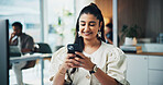 Woman, phone and happy with texting at office with contact, scroll and check notification at media agency. Person, writer and smartphone with typing, mobile app and smile with coworking at company