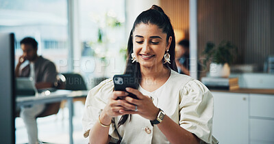 Buy stock photo Woman, phone and happy with texting at office with contact, scroll and check notification at media agency. Person, writer and smartphone with typing, mobile app and smile with coworking at company