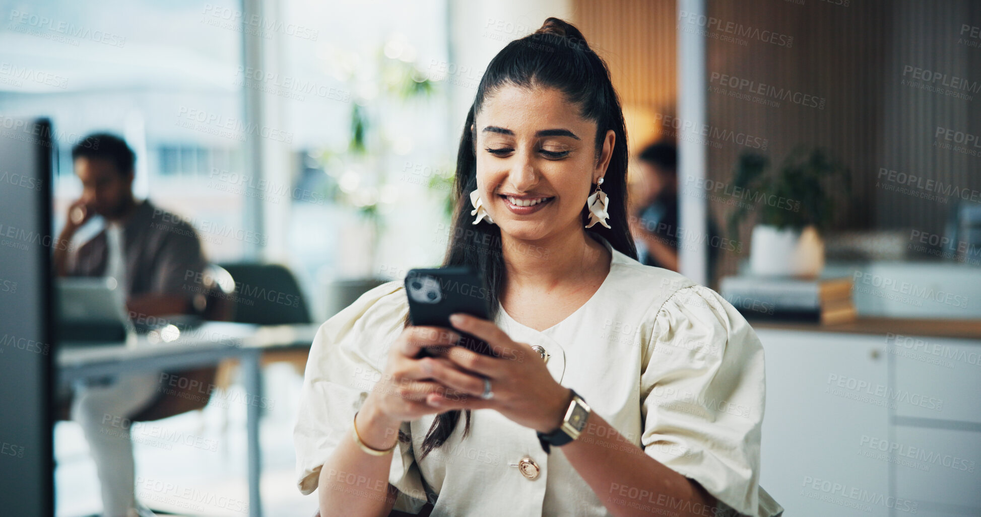 Buy stock photo Woman, phone and happy with texting at office with contact, scroll and check notification at media agency. Person, writer and smartphone with typing, mobile app and smile with coworking at company