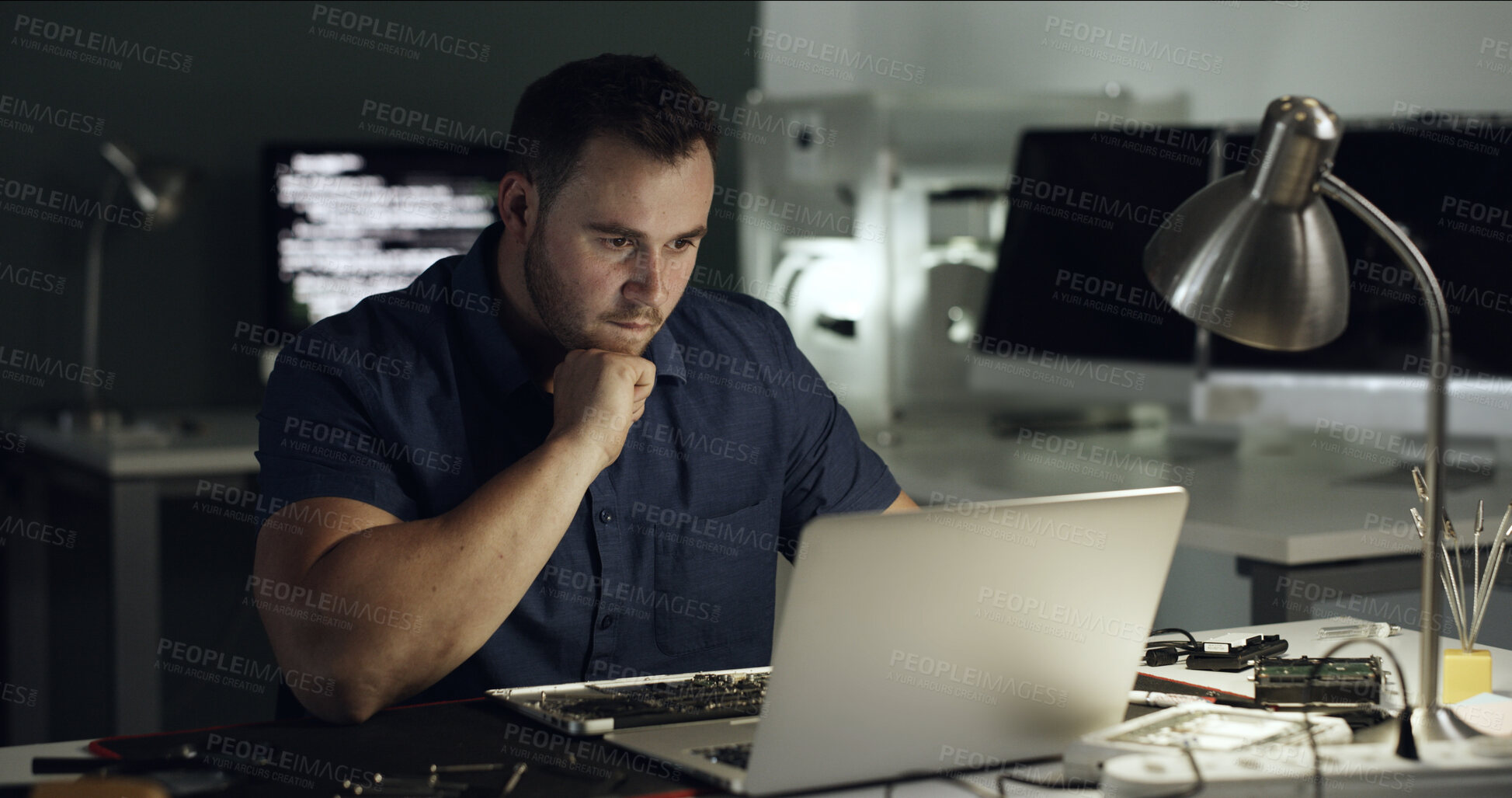 Buy stock photo Repair, man and thinking with laptop in office at night for diagnostic solution, hardware testing and IT. Deadline, technician and tech at desk for troubleshooting, trace signal and problem solving