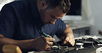 Soldering, repair or man in workshop with circuit board, inspection or wiring assemble in hardware check. Electronics, tech or engineer with motherboard, restoration tool or maintenance in system fix