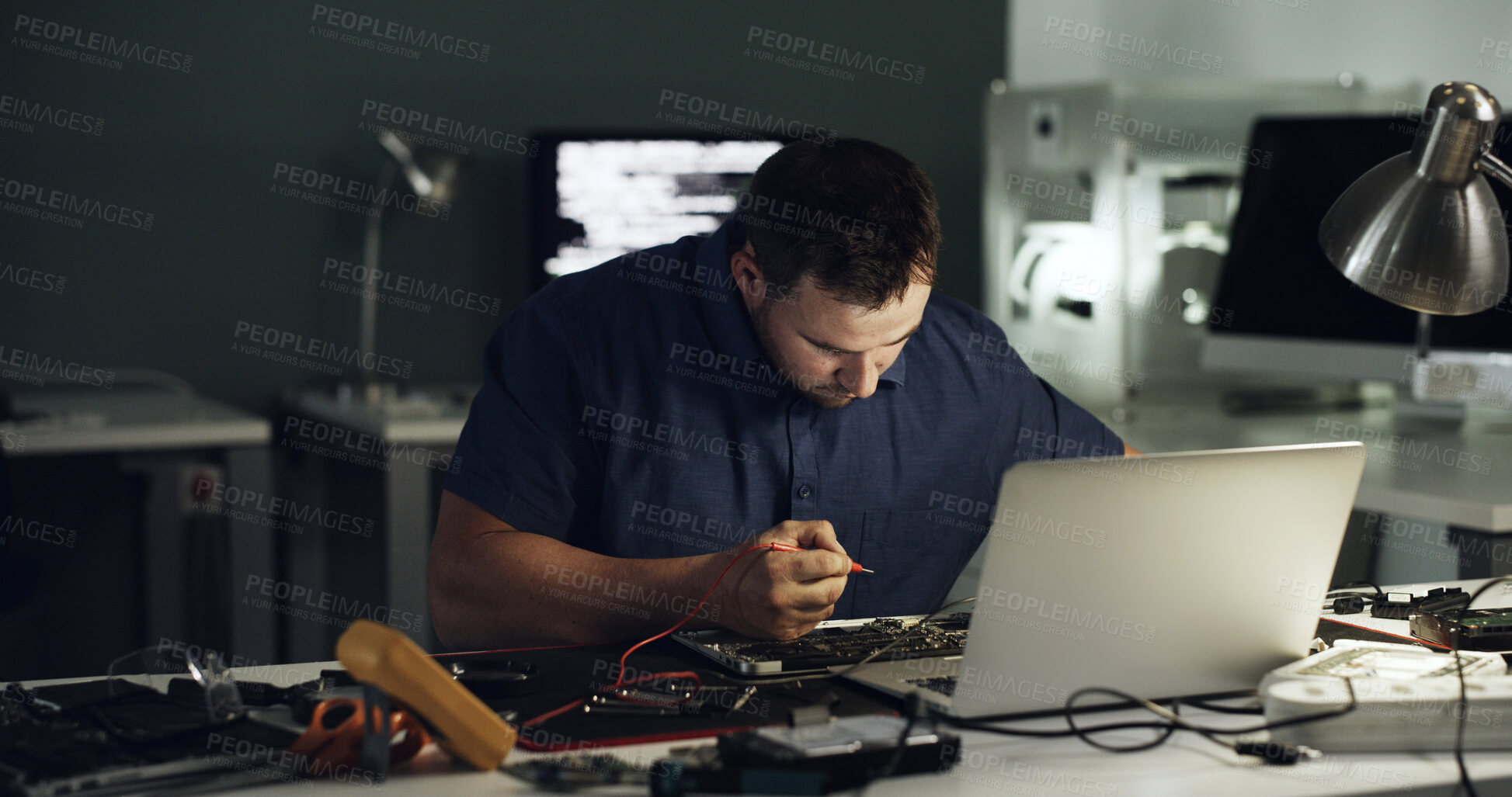 Buy stock photo Tools, man and laptop repair in office for hardware diagnostics, measure voltage or troubleshooting. Night, technician and multimeter probe on circuit board for continuity test, broken traces and IT
