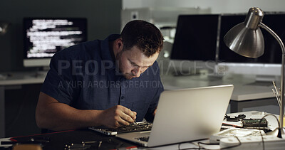 Buy stock photo Technician, night and man on laptop for repair, maintenance and troubleshooting with hardware. Office, IT and person on computer with tools for software upgrade, diagnostics and check motherboard