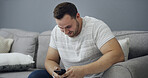 Man, smile and browsing on couch with phone, online dating app notification or text message on weekend. Happy, person relax and reading in home with tech, social media post and digital communication.
