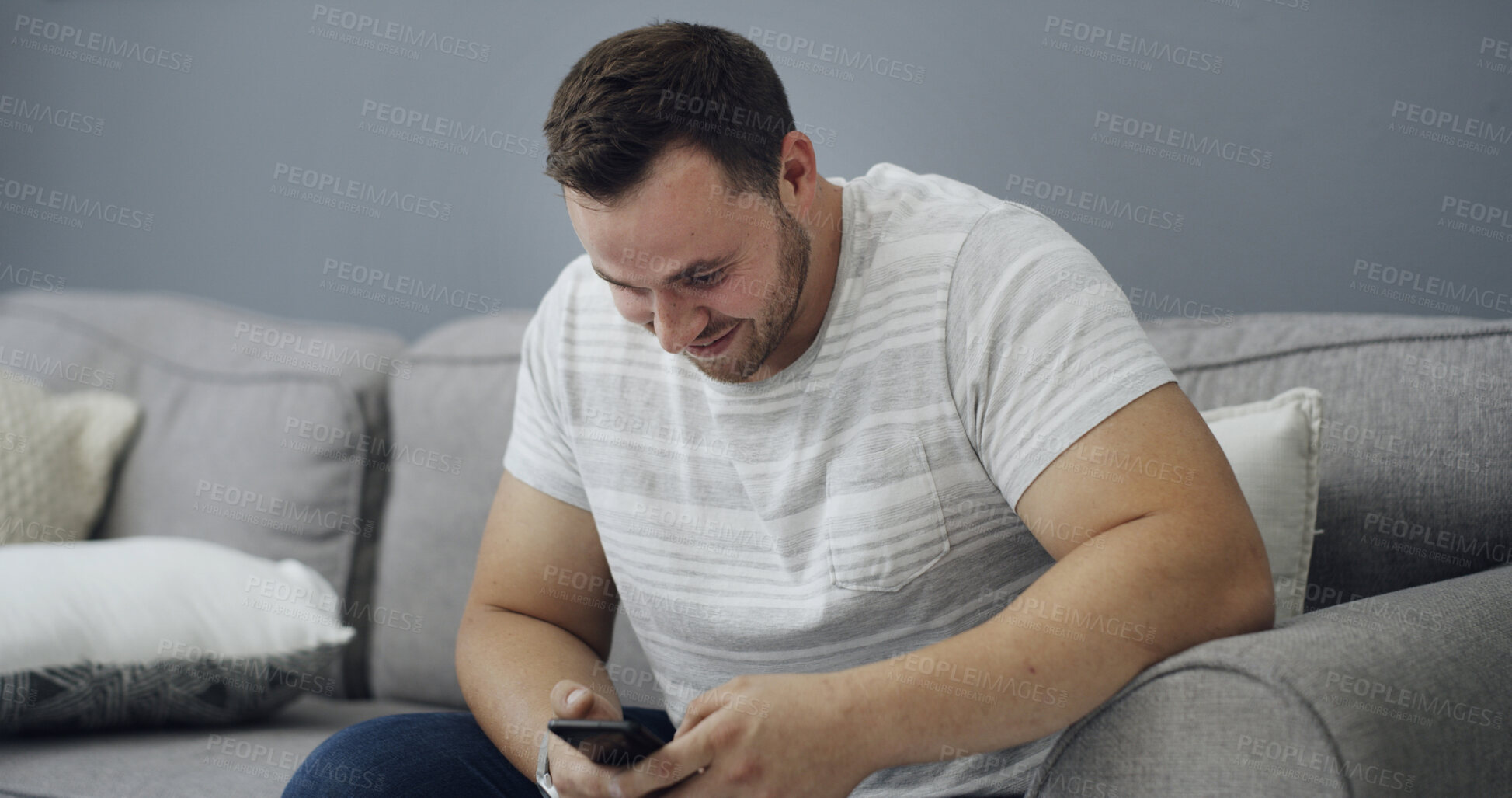 Buy stock photo Man, smile and browsing on couch with phone, online dating app notification or text message on weekend. Happy, person relax and reading in home with tech, social media post and digital communication.