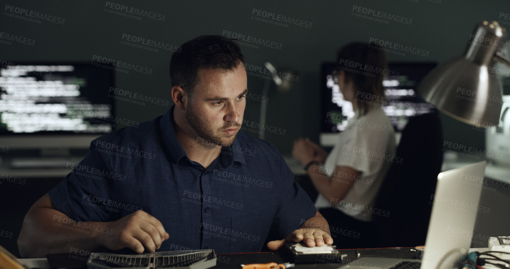Buy stock photo Night, laptop and man with hardware for IT maintenance, repair and diagnostics for software. Technology, technician and team of workers with tools for troubleshooting, system test or programming