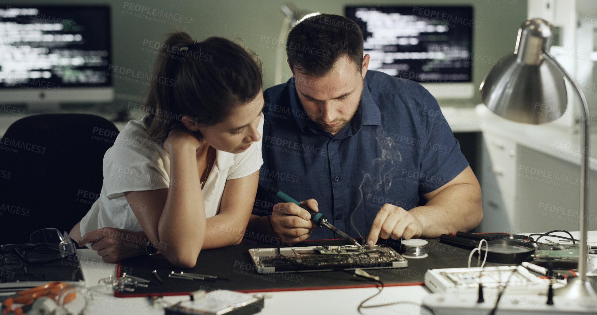 Buy stock photo Soldering, repair or team in workshop with circuit board, inspection or wiring guidance in hardware check. Electronics, people or engineers with tech, testing advice or collaboration in system fix.