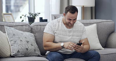 Buy stock photo Man, smile and scroll on sofa with phone, text message notification and download app for online dating. Happy, person relax and reading in home with tech, social media post and digital communication.