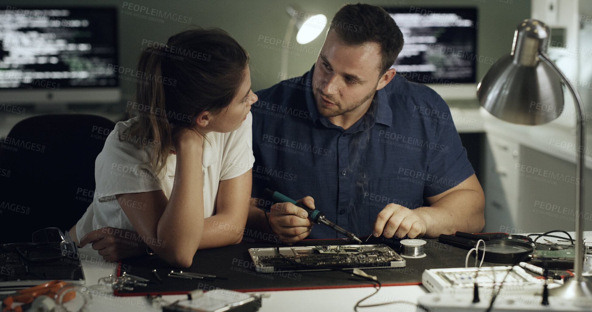 Buy stock photo Soldering, repair or team in office with circuit board, inspection or wiring guidance in hardware check. Electronics, people or engineers with tech, testing advice or collaboration in system fix.