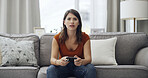 Frustrated, woman or gamer with controller on sofa for serious competition or match in home. Female person, POV or playing with console remote on couch for gaming entertainment or online subscription