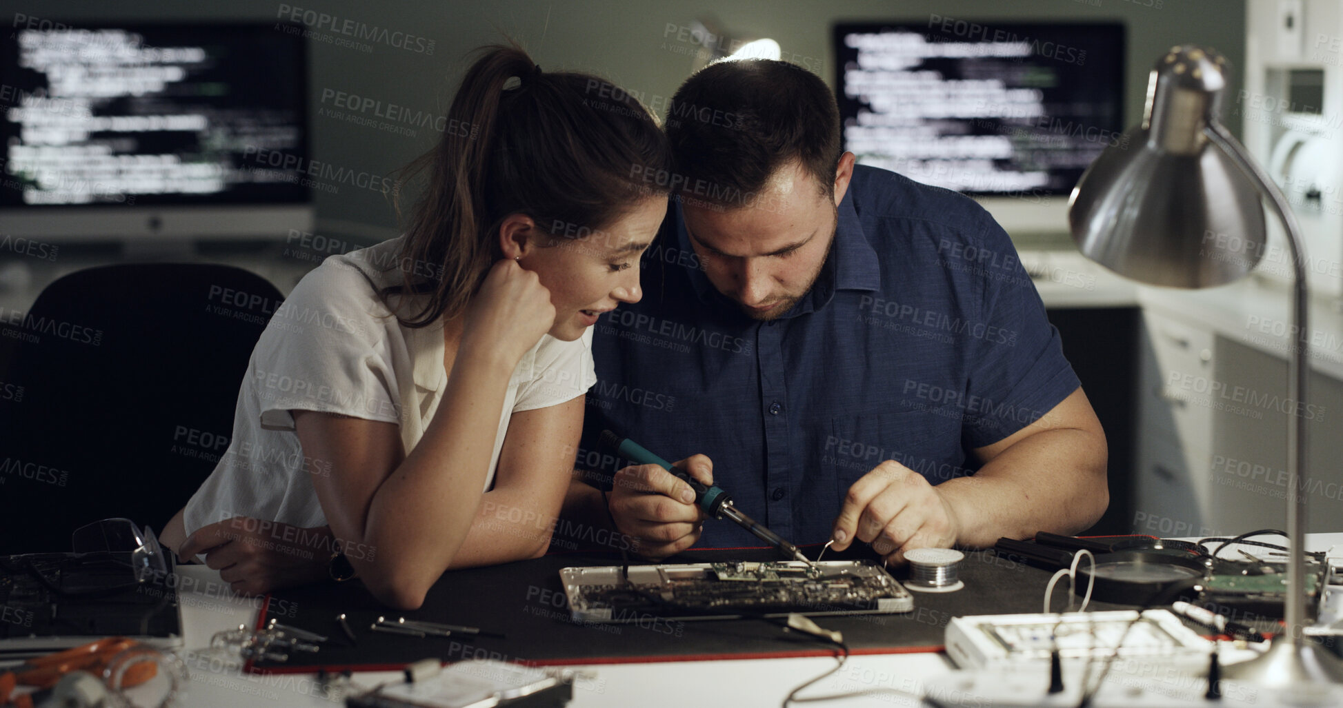 Buy stock photo Night, motherboard and team with welding for IT maintenance, repair and diagnostics for hardware. Technology, technician and engineer people with tools for troubleshooting, system test or soldering