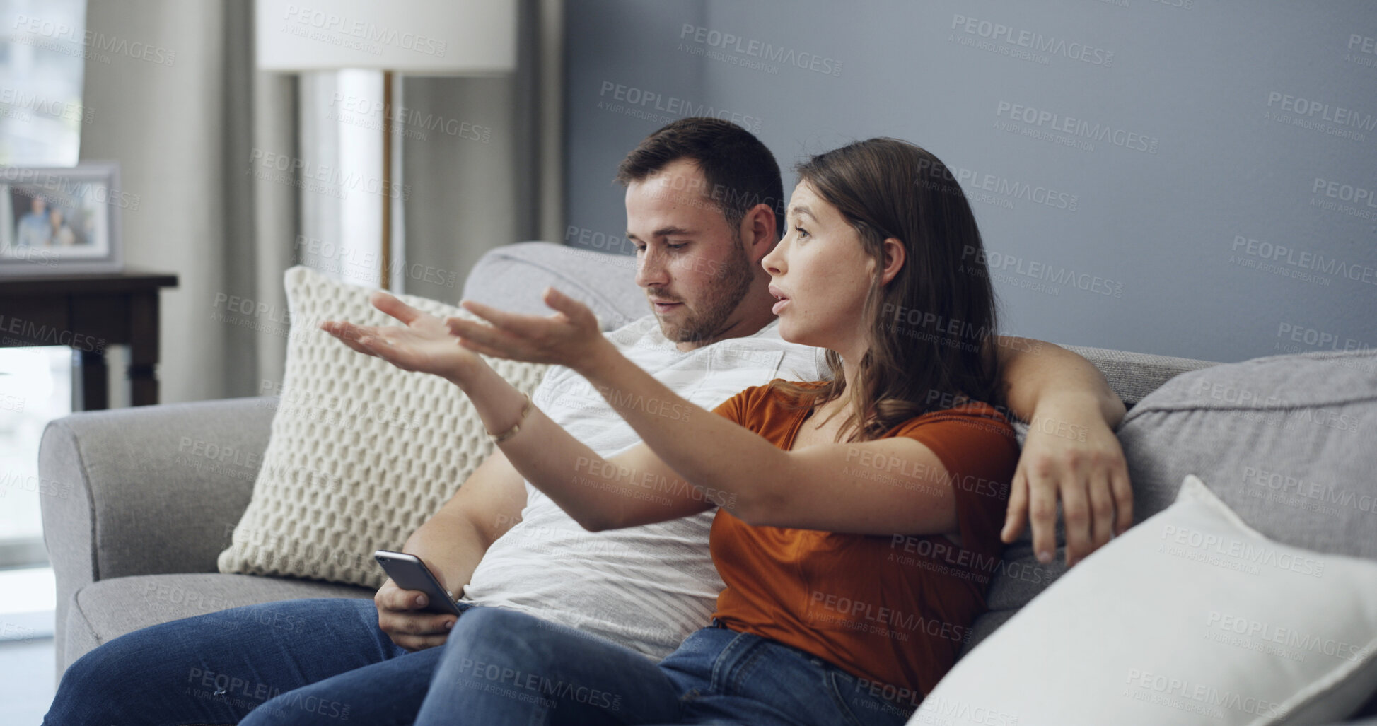 Buy stock photo Phone, argue and couple watching tv on couch, bonding distraction or upset for missing movie scene. Talk, unhappy partner or people with mobile for social media in home, lack of attention or presence