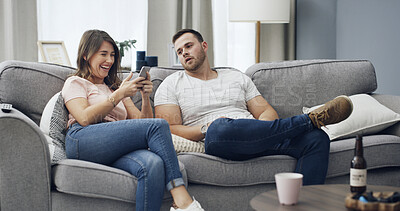 Buy stock photo Cellphone, jealous and couple on sofa in home with texting, chatting or networking with conflict. Laugh, upset and people with phone for contact on mobile app with fighting in living room at house.