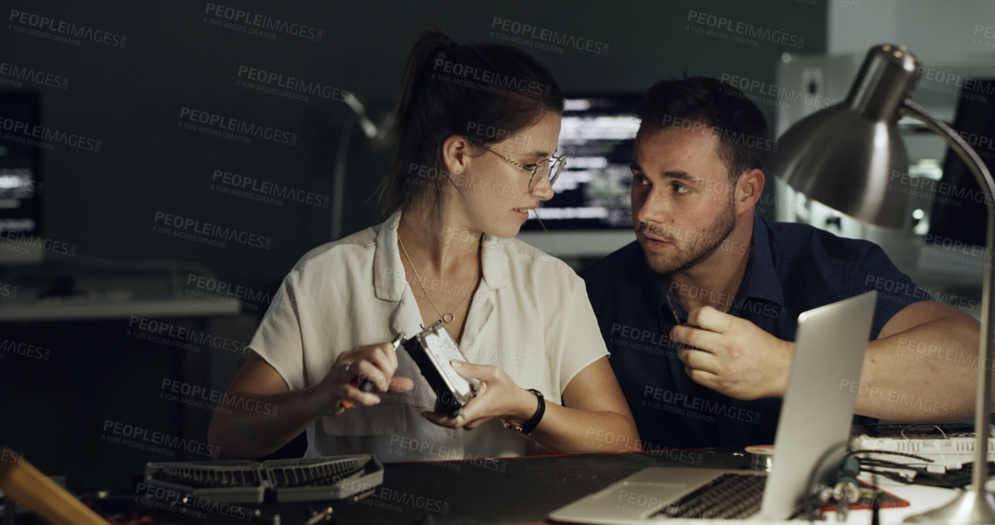 Buy stock photo Night, laptop and team with hardware for IT maintenance, repair and diagnostics for software. Technology, technician and engineer people with tools for troubleshooting, system test or programming