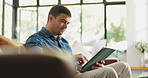 Relax, man or scroll on tablet on sofa for social media post, streaming subscription or weekend break. Serious, person and tech in home for watching online videos, app download and email notification