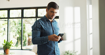 Buy stock photo Home, coffee and man with smartphone, texting or communication with contact on web, serious and chat. Reading, online and person with beverage in house, scroll and message with mobile on social media