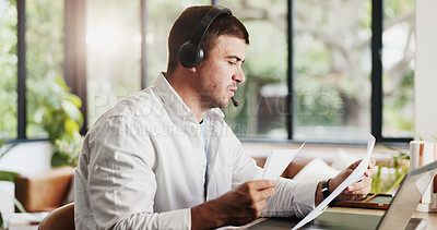 Buy stock photo Businessman, consultant and documents with headset in home for online advice or customer service. Man, freelance agent or remote work with laptop or paperwork for virtual assistance or help in house