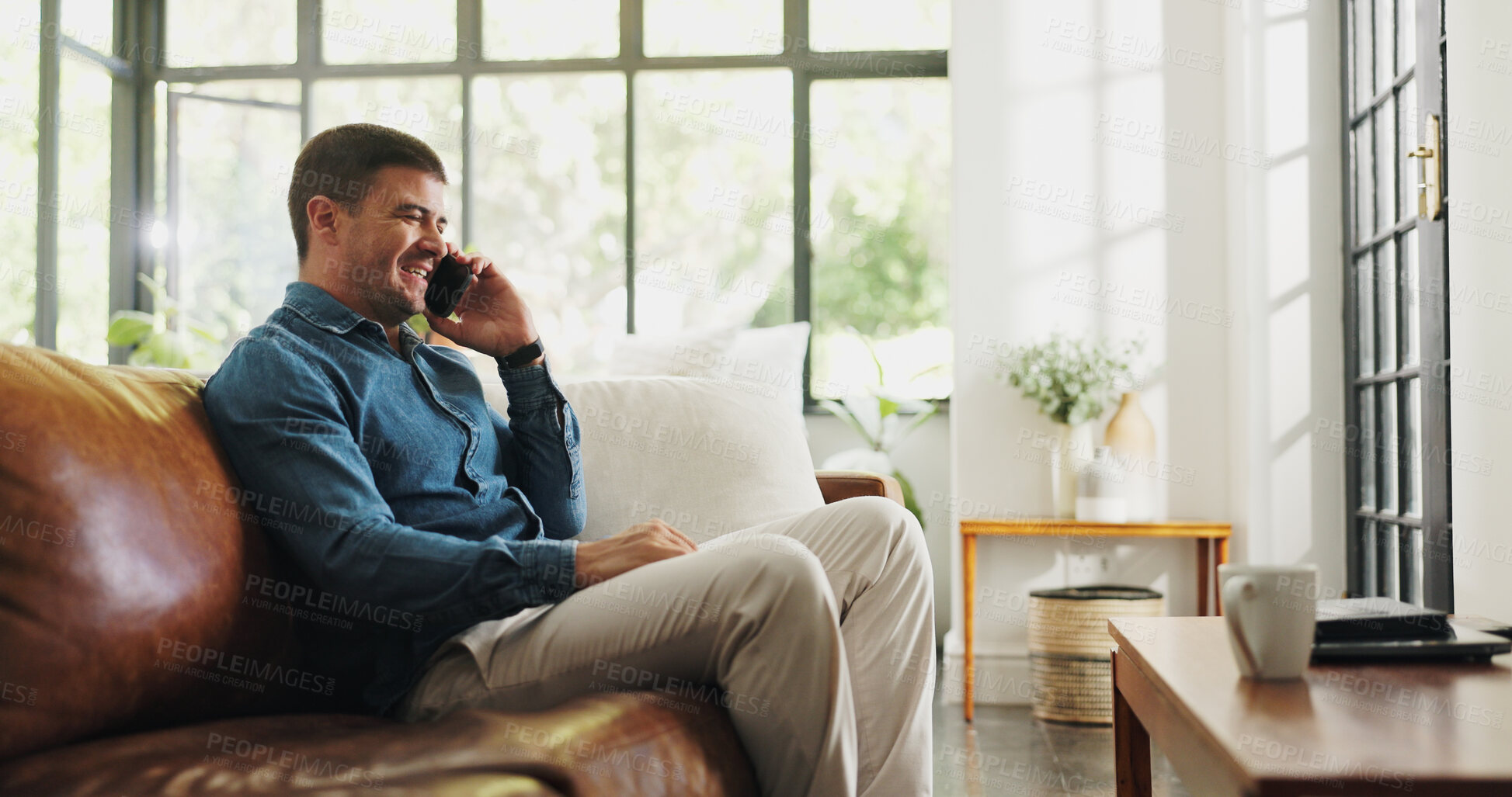 Buy stock photo Phone call, relax and man on sofa in home with communication, contact or networking in living room. Cellphone, happy and male person on mobile conversation for gossip or connection in apartment.