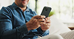 Typing, phone and hands of man on sofa for social media, reading news and online message in home. Weekend, relax and person on smartphone for connection, communication and internet in living room