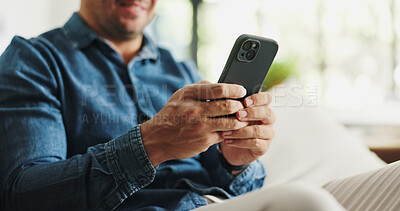 Buy stock photo Typing, phone and hands of man on sofa for social media, reading news and online message in home. Weekend, relax and person on smartphone for connection, communication and internet in living room