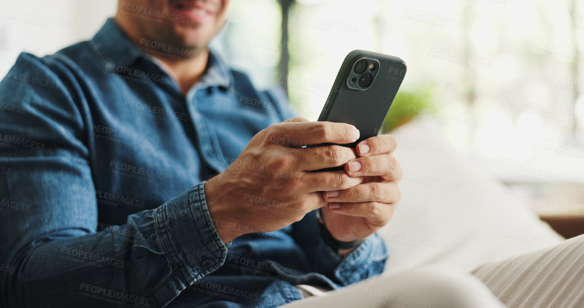 Buy stock photo Typing, phone and hands of man on sofa for social media, reading news and online message in home. Weekend, relax and person on smartphone for connection, communication and internet in living room