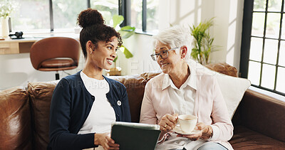 Buy stock photo Old woman, nurse and tablet on couch with laugh for streaming, video or article in living room. People, caregiver and elderly person with tech, app and happy with drink on sofa in retirement at house
