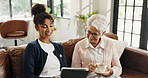 Old woman, nurse and tablet on couch with tea for streaming, video or article in living room. People, caregiver and elderly person with tech, application and happy on sofa in retirement at house